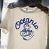White t-shirt with blue 'Oceanic Time' anchor design held by a person.